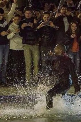 Making a splash: Kanye West takes a dive in Swan Lake during a free show in Armenia in April.