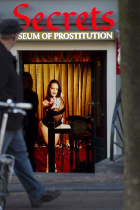 A hologram of a beckoning prostitute at the entrance.