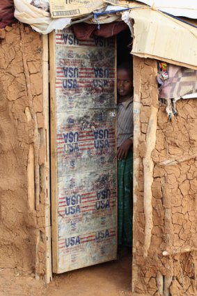 A refugee shelters in a camp near the Somalian border.