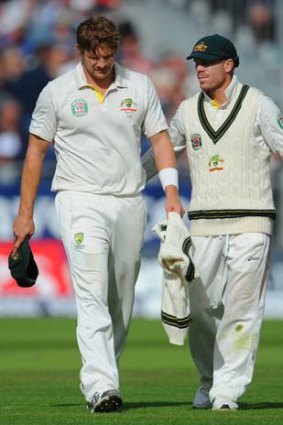 David Warner (right) consoles Shane Watson as he leaves the field.
