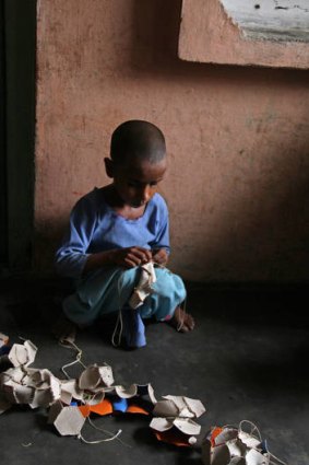 Seven-year-old Shama stitches balls in her village of Rasoolpur Chhodi, in India's Punjab. Shama says she sometimes goes to school, 'but I like stitching'.