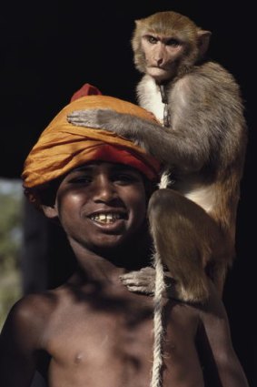 Another India ... a boy and his macaque.