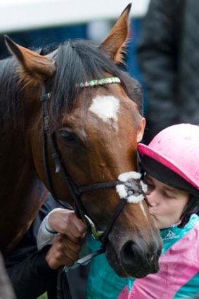 Jockey Tom Queally kisses Frankel after his final race.