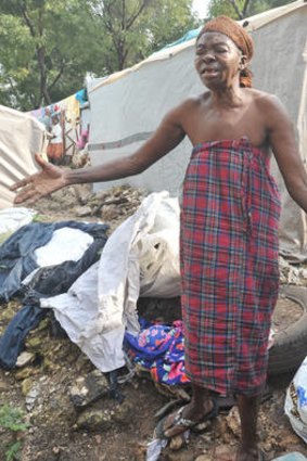 An elderly woman weeps outside her dwelling in a tent city in Port-au-Prince following the destruction caused by Hurricane Sandy.  Many Port-au-Prince residents are still living in vast tented areas after the catastrophic 2010 earthquake.