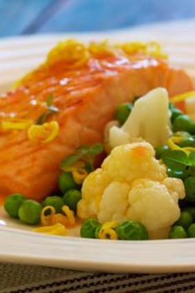 Grilled Atlantic salmon with cauliflower, peas and citrus sauce.