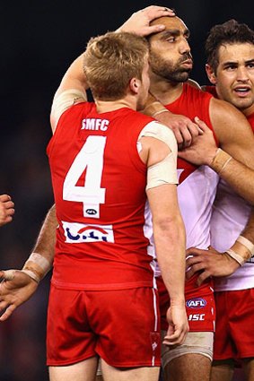 Adam Goodes (centre) is consoled by teammates.