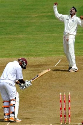 Indian bowler Harbhajan Singh celebrates his 400th Test wicket after bowling out West Indies batsman Carlton Baugh during the second day of third and final Test match between India and West Indies in Dominica.