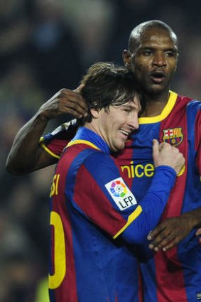 Conquered cancer: Eric Abidal with then-Barcelona teammate, Lionel Messi.