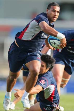 Hard to stop: Melbourne's Cooper Vuna breaks a tackle at Rebels training on Wednesday.