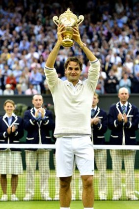 Still a winner ... Roger Federer with this year's Wimbledon trophy.