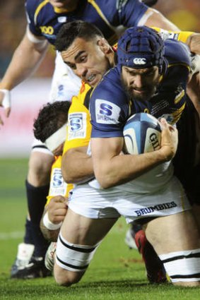 On their knees: Scott Fardy of the Brumbies tackled by the Chiefs' Liam Messam.