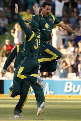 Clint McKay (right) celebrates taking the wicket of Dinesh Chandimal with teammate David Warner.