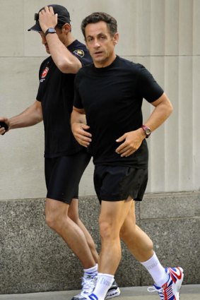 Collapsed while jogging .... French President Nicolas Sarkozy pictured here on a morning run on July 19.