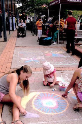 Family time: Chalk drawing at the Parties at the Shops event at Wanniassa.