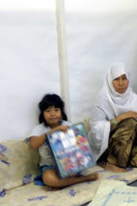 Ali Hussaini with wife Batool, daughter Zahra, 6, and son Saqlain Abbas, 2, in their room in Nauru state house camp in 2005.