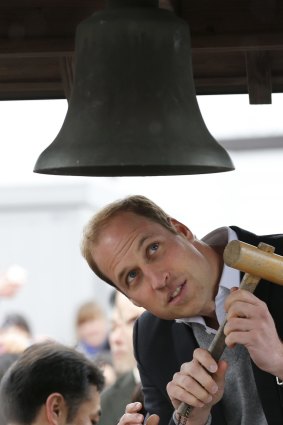 Britain's Prince William looks at the Chime of Hope as he rings the bell in a neighborhood destroyed by the March 11, 2011 earthquake and tsunami in Onagawa, Miyagi Prefecture.