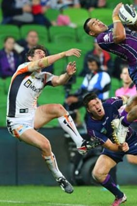 Flying high: Melbourne Storm's Mahe Fonua catches a high ball in the win against Wests Tigers at AAMI Park on Monday night.