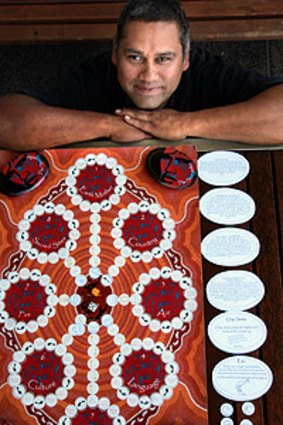 Glenn Shea with his board game that he hopes will help others learn about Aboriginal culture.