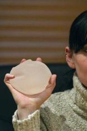 Cancer concerns: Alexandra Blachere, who heads an association of women with faulty breast implants, displays silicone gel implants during an interview in Paris.