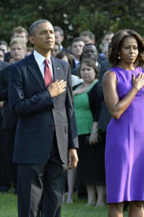 US President Barack Obama and First Lady Michelle Obama observe a moment of silence at the White House in Washington, DC,  to mark the 12th anniversary of the 9/11 attacks.