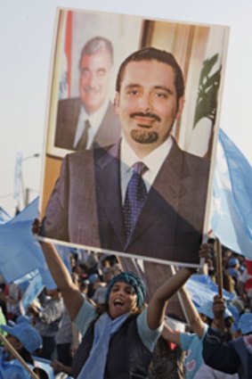 A supporter carries a placard of Saad Hariri during a Beirut rally.