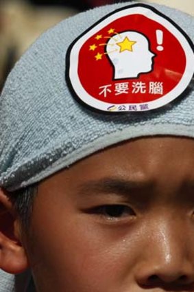 ''No brainwashing'' ... a child's protest badge says.