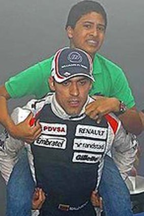 Hero ... Pastor Maldonado carries his young cousin to safety.