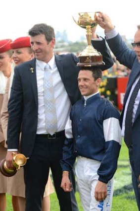 Trainer Robert Hickmott, jockey Brett Prebble and owner Nick Williams after Prebble won the 2012 Melbourne Cup on Green Moon.