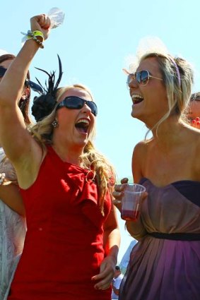 Racegoers cheer as they watch a race during the Caulfield Guineas Day at Caulfield Racecourse.