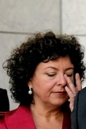Therese Rein wipes a tear during his press conference after he renounced the prime ministership.