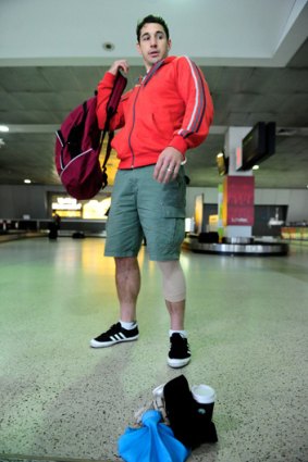 Walking wounded: Billy Slater arrives in Melbourne yesterday.