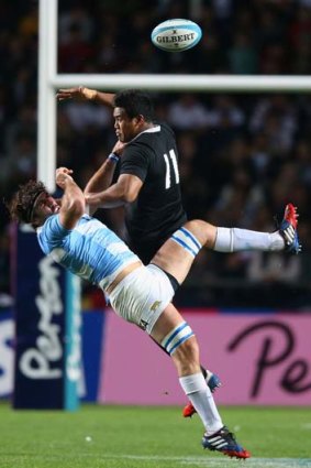 Juan Martin Fernandez Lobbe is challenged by New Zealand winger Julian Savea during the Rugby Championship match on September 28.