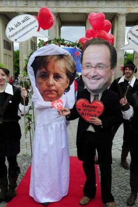 Shotgun wedding: Activists from Oxfam and the Attac group in Berlin ''marry'' Angela Merkel to Francois Hollande and his ''taxes against poverty'', which would put a levy on financial transactions.