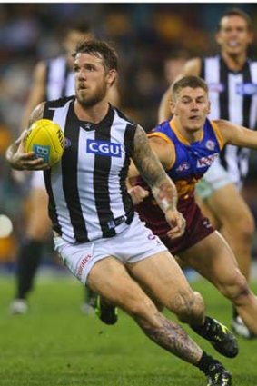 Step ahead: Dane Swan charges away from the Lions on Friday night.