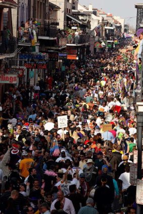 Mardi Gras revelers walk up and down on Bourbon Street on Mardi Gras day in New Orleans, Louisiana.