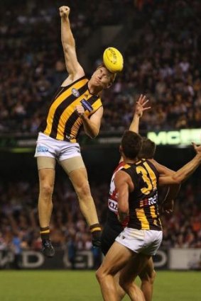 On the fly: Kyle Cheney reaches for the ball against Essendon.