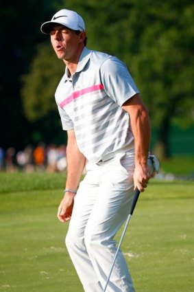 Rory McIlroy of Northern Ireland reacts after a putt on the 17th green.