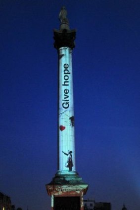 A projection of a stencil by the artist Banksy on Nelson's Column in London marks the third anniversary of the Syrian conflict. 