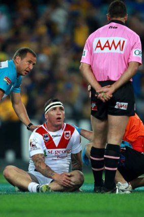 Dazed ... Josh Miller of the Dragons after being hit in a high tackle by Reni Maitua of the Eels.