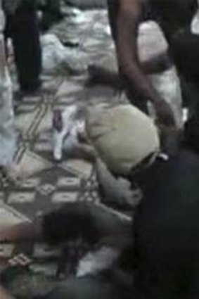 The wounded lay on the ground at Mazraat al-Qabeer near Hama where up to 87 people were killed.