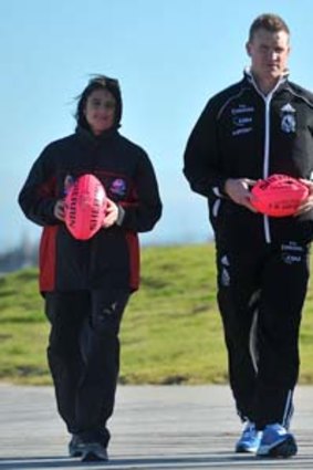 Nathan Buckley with female coaches Peta Searle and Nicole Graves at St Kilda beach yesterday.