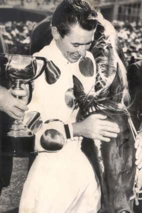 Jockey Roy Higgins celebrates winning the 1965 Melbourne Cup on Light Fingers.