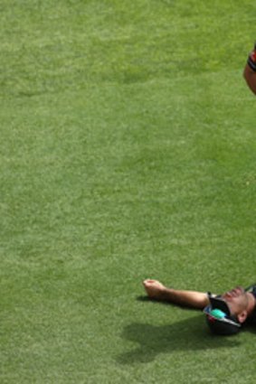 Ricky Ponting gets worked on during Australia's net session at the Gabba yesterday.