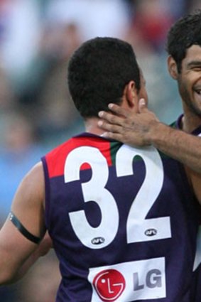 A football character: Jeff Farmer embraces Peter Bell.