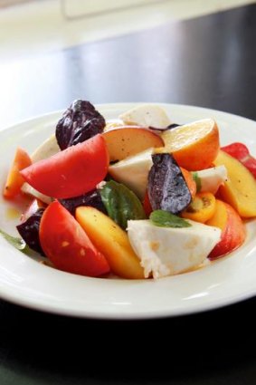 Salad with summer peach, heirloom tomatoes, buffalo mozzarella and purple basil.