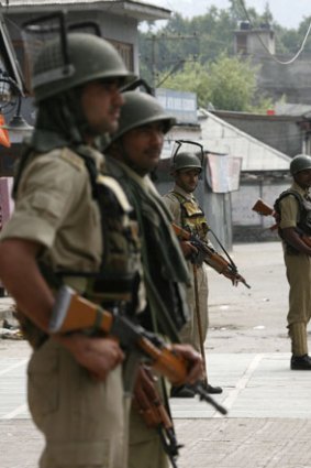 Indian police stand guard in Srinagar, Kashmir. More than 2000 bodies have been found in unmarked graves in the divided region.