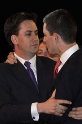 Photo finish ... Ed Miliband, left, Labour’s new leader, embraces his brother David.