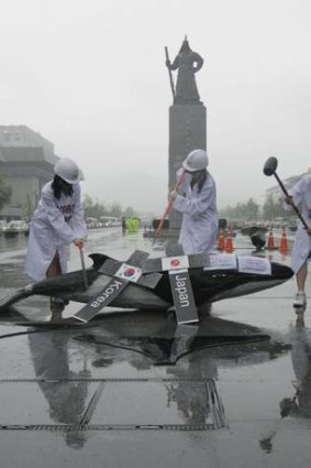 Environmental activists in central Seoul protest South Korea's plans to resume whaling.
