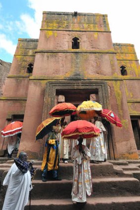 Ethiopian Orthodox Christian priests and monks leave mass at the Bete Giyorgis rock-hewn church.