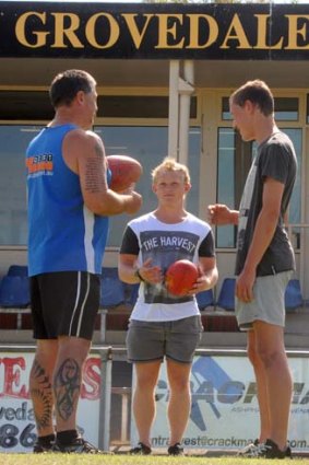 Thinking big: Nathan Deans is dwarfed by Grovedale's Garry Goggin (left) and Andrew French.